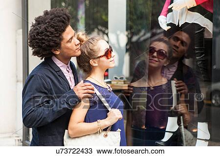 Stock Image - Young couple window shopping. Fotosearch