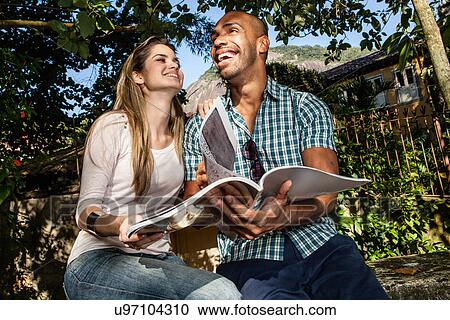 Young couple with book, Rio de Janeiro, Brazil View Large Photo Image Stock Image - Young couple with book, Rio de Janeiro, Brazil. Fotosearch