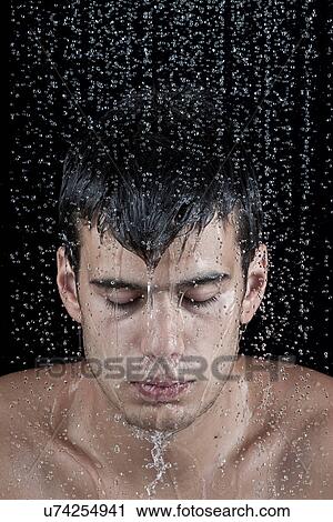 Young man covered with water droplets View Large Photo Image Stock Image - Young man covered with water droplets. Fotosearch