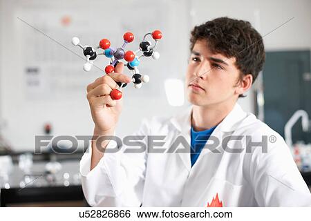 Young man holding molecular model View Large Photo Image Stock Photograph - Young man holding molecular model. Fotosearch