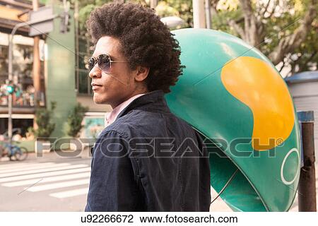 Young man in sunglasses by pay telephone View Large Photo Image Stock Image - Young man in sunglasses by pay telephone. Fotosearch