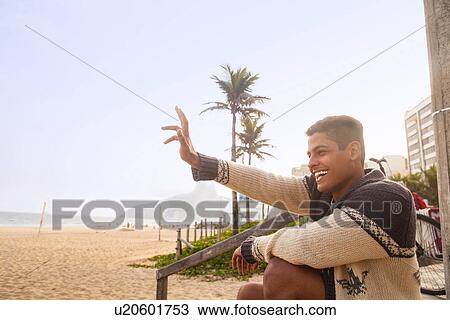 Young man waving, Ipanema Beach, Rio de Janeiro, Brazil View Large Photo Image Stock Image - Young man waving, Ipanema Beach, Rio de Janeiro, Brazil. Fotosearch
