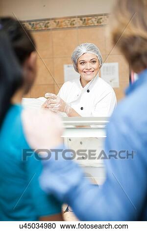 Young sales assistant at counter View Large Photo Image Stock Image - Young sales assistant at counter. Fotosearch