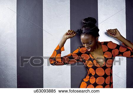 Stock Photography - Young woman dancing alone in club. Fotosearch