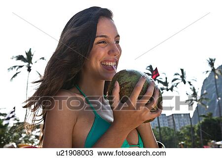 Young woman drinking coconut drink View Large Photo Image Stock Image - Young woman drinking coconut drink. Fotosearch