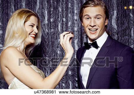 Young woman feeding chocolate to boyfriend View Large Photo Image Stock Image - Young woman feeding chocolate to boyfriend. Fotosearch
