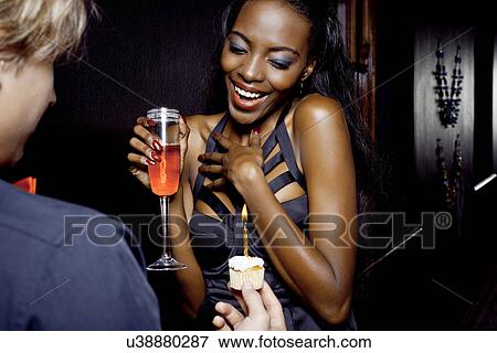 Young woman getting birthday cake in nightclub View Large Photo Image Stock Photo - Young woman getting birthday cake in nightclub. Fotosearch