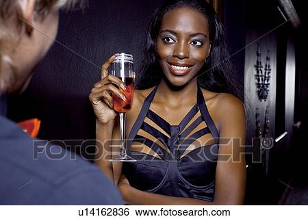 Stock Photograph - Young woman getting chatted up in club. Fotosearch