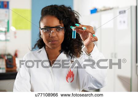 Young woman holding chemical sample View Large Photo Image Stock Photograph - Young woman holding chemical sample. Fotosearch