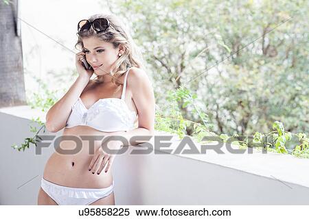 Young woman in bikini, talking on cellphone View Large Photo Image Stock Photography - Young woman in bikini, talking on cellphone. Fotosearch