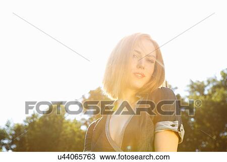 Young woman in bright sunlight View Large Photo Image Stock Image - Young woman in bright sunlight. Fotosearch