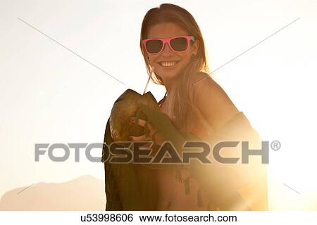Young woman in sunlight with coconut drink View Large Photo Image Stock Photograph - Young woman in sunlight with coconut drink. Fotosearch