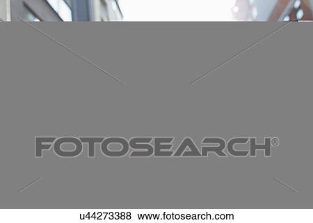 Stock Photo - Young woman looking up. Fotosearch