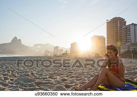 Young woman on beach using cellphone, Ipanema Beach, Rio, Brazil View Large Photo Image Stock Image - Young woman on beach using cellphone, Ipanema Beach, Rio, Brazil. Fotosearch