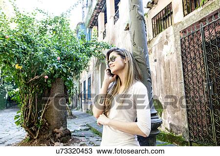 Young woman on cell phone, Rio de Janeiro, Brazil View Large Photo Image Stock Image - Young woman on cell phone, Rio de Janeiro, Brazil. Fotosearch