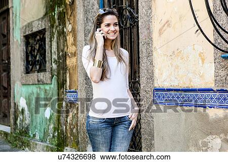 Young woman on cell phone, Rio de Janeiro, Brazil View Large Photo Image Stock Photo - Young woman on cell phone, Rio de Janeiro, Brazil. Fotosearch