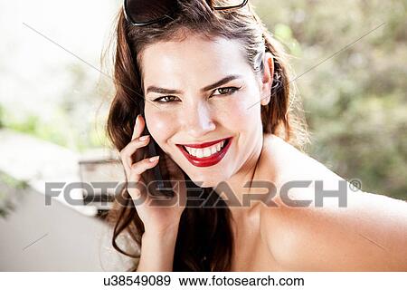 Young woman on cell phone View Large Photo Image Stock Photo - Young woman on cell phone. Fotosearch