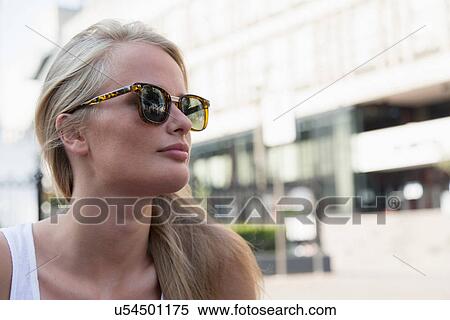 Stock Photography - Young woman outside building. Fotosearch