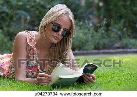 Picture - Young woman reading book. Fotosearch