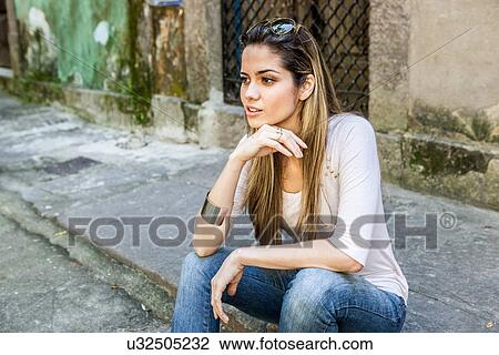 Young woman sitting on kerb, Rio de Janeiro, Brazil View Large Photo Image Stock Image - Young woman sitting on kerb, Rio de Janeiro, Brazil. Fotosearch