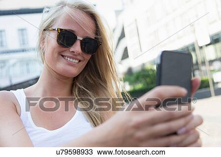 Young woman using cellular phone View Large Photo Image Stock Image - Young woman using cellular phone. Fotosearch