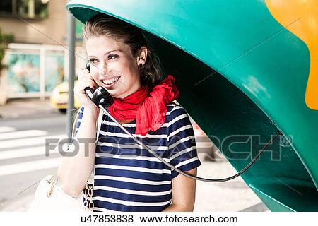 Young woman using pay telephone View Large Photo Image Stock Photo - Young woman using pay telephone. Fotosearch