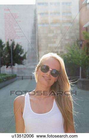 Young woman walking carefree in street View Large Photo Image Stock Photograph - Young woman walking carefree in street. Fotosearch