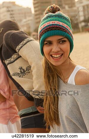 Young woman wearing knit hat on beach View Large Photo Image Stock Photo - Young woman wearing knit hat on beach. Fotosearch