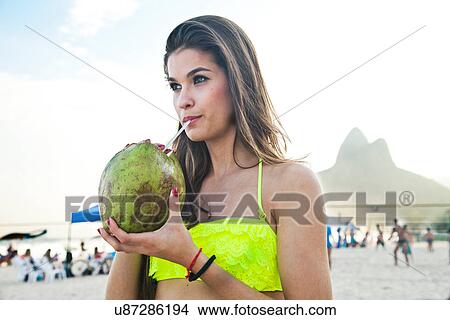 Young woman with coconut drink, Ipanema Beach, Rio, Brazil View Large Photo Image Picture - Young woman with coconut drink, Ipanema Beach, Rio, Brazil. Fotosearch