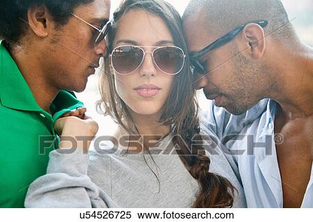 Stock Photography - Young woman with man on each side of her. Fotosearch