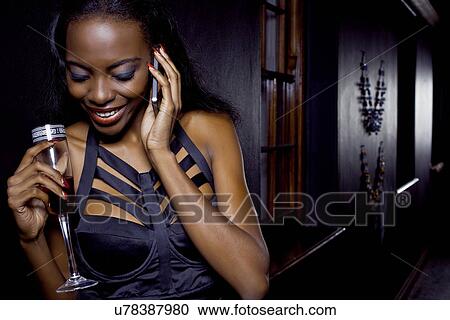 Young woman with mobile in nightclub View Large Photo Image Stock Image - Young woman with mobile in nightclub. Fotosearch