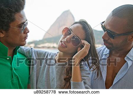 Young woman with two male friends, Rio de Janeiro, Brazil View Large Photo Image Stock Photo - Young woman with two male friends, Rio de Janeiro, Brazil. Fotosearch