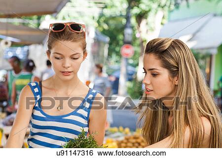 Young women in market View Large Photo Image Stock Photograph - Young women in market. Fotosearch