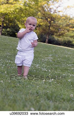 Stock Image - Baby (12-17 months) playing in park. Fotosearch