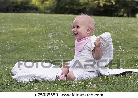 Stock Image - Baby (12-17 months) playing in park. Fotosearch