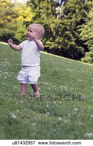 Stock Photo - Baby (12-17 months) playing in park. Fotosearch