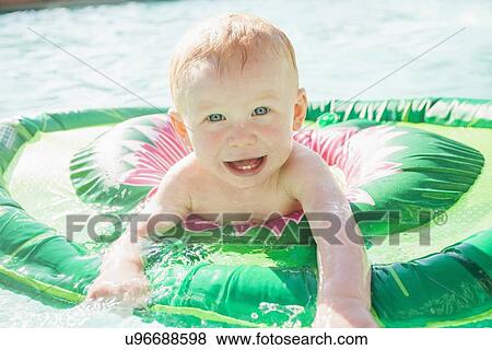 Stock Photo - Baby Boy (18-23 months) playing in swimming pool. Fotosearch