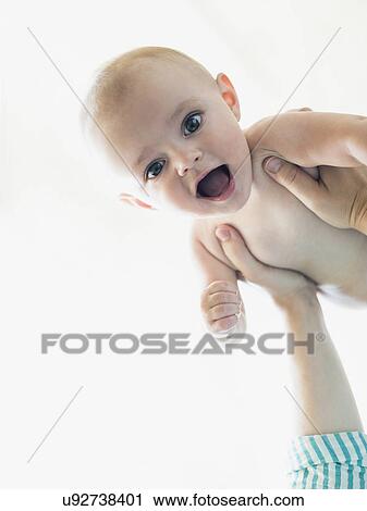 Baby boy (6-11 months) held by mother View Large Photo Image Stock Image - Baby boy (6-11 months) held by mother. Fotosearch