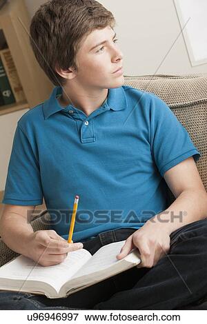 Stock Photo - Boy (14-15) studying. Fotosearch