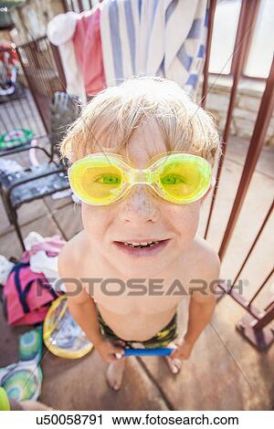 Boy (4-5) posing in swimming goggles View Large Photo Image Stock Image - Boy (4-5) posing in swimming goggles. Fotosearch