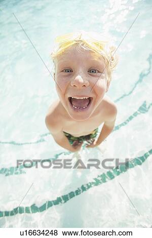 Stock Photo - Boy (4-5) posing in swimming pool. Fotosearch