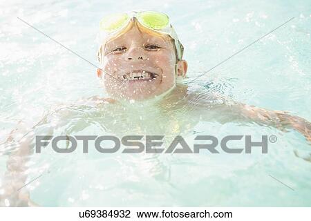 Boy (4-5) swimming in swimming pool View Large Photo Image Stock Image - Boy (4-5) swimming in swimming pool. Fotosearch