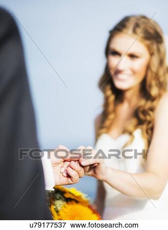 Stock Photo - Bride and groom holding hands. Fotosearch