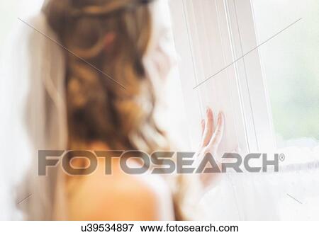 Bride looking out window View Large Photo Image Stock Photo - Bride looking out window. Fotosearch