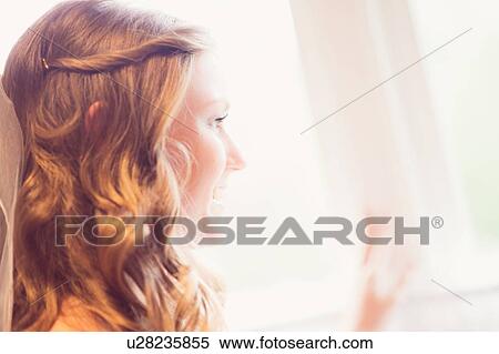 Stock Photography - Bride looking out window. Fotosearch