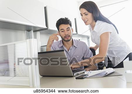 Business man and woman at work in office View Large Photo Image Picture - Business man and woman at work in office. Fotosearch