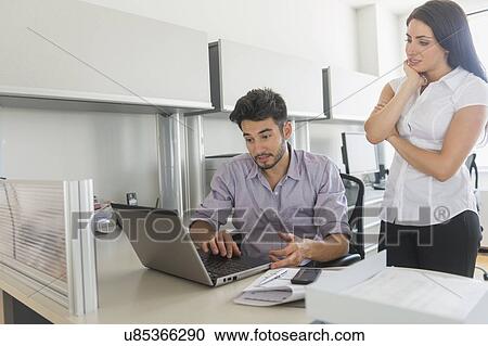 Business man and woman at work in office View Large Photo Image Stock Image - Business man and woman at work in office. Fotosearch