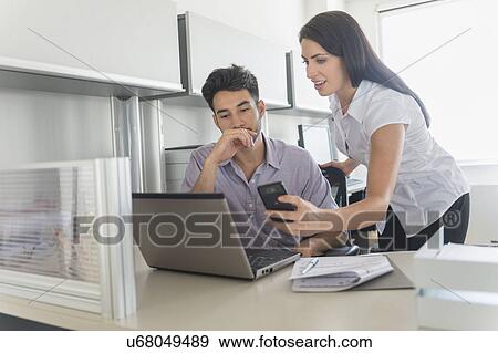 Business man and woman at work in office View Large Photo Image Stock Photo - Business man and woman at work in office. Fotosearch