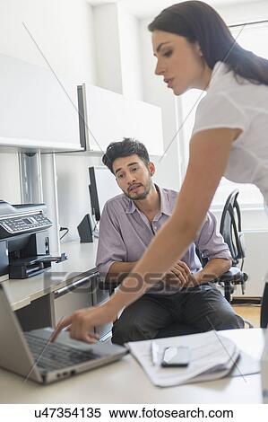 Business man and woman at work in office View Large Photo Image Stock Photography - Business man and woman at work in office. Fotosearch