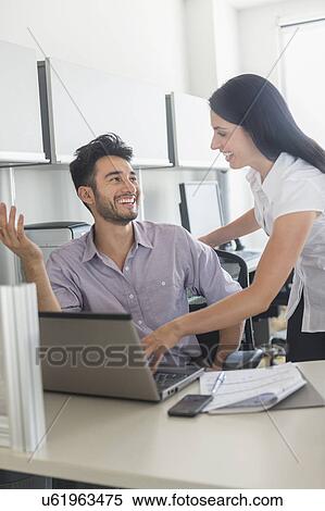 Stock Photography - Business man and woman at work in office. Fotosearch